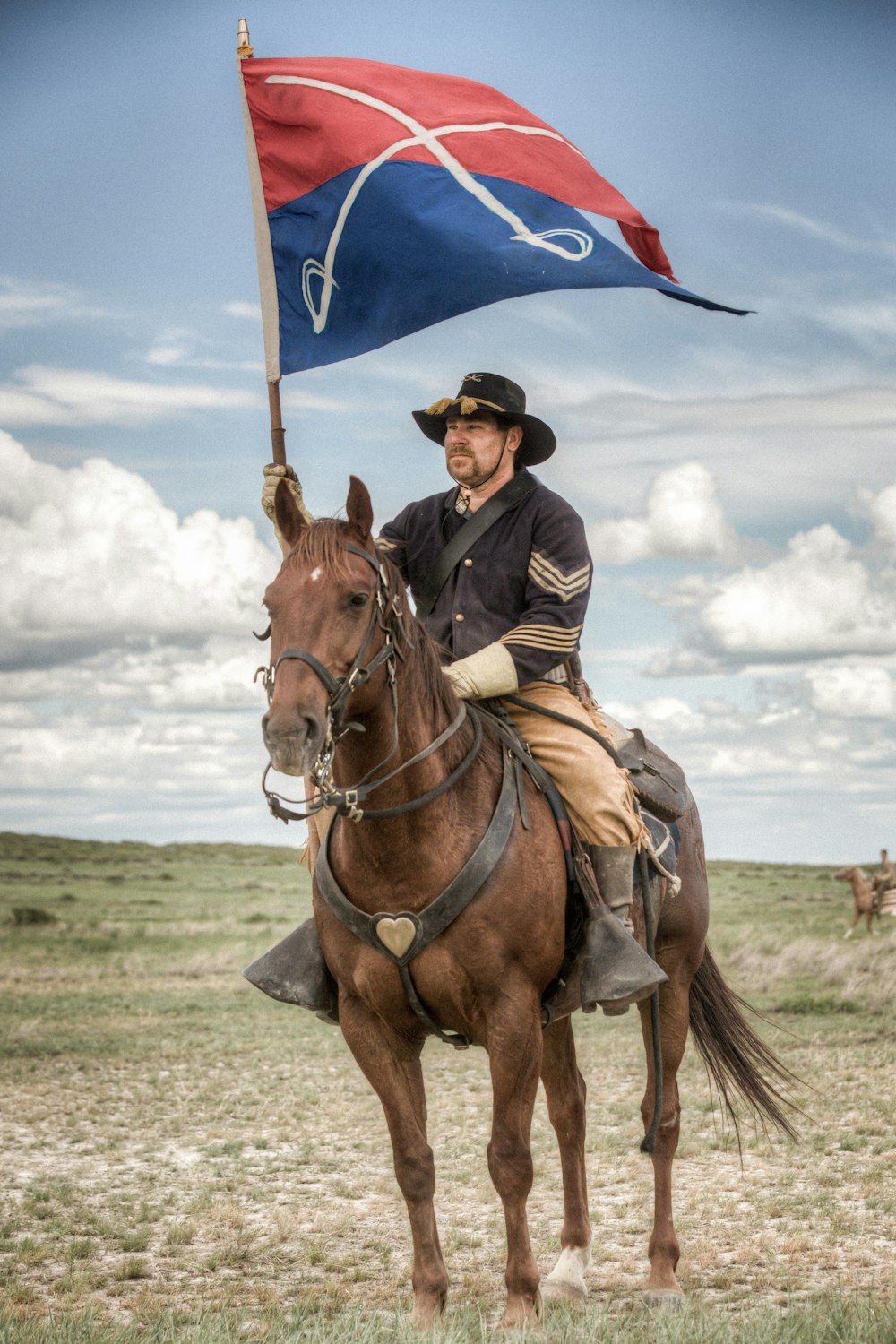 man in black jacket riding brown horse during daytime