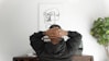 man in gray hoodie sitting on chair