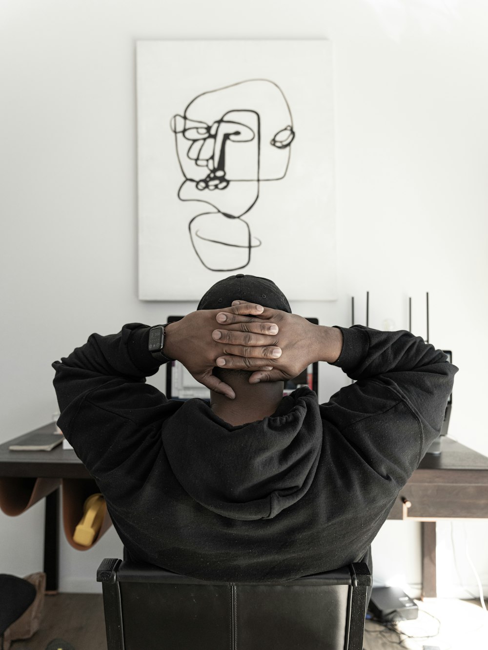 man in gray hoodie sitting on chair