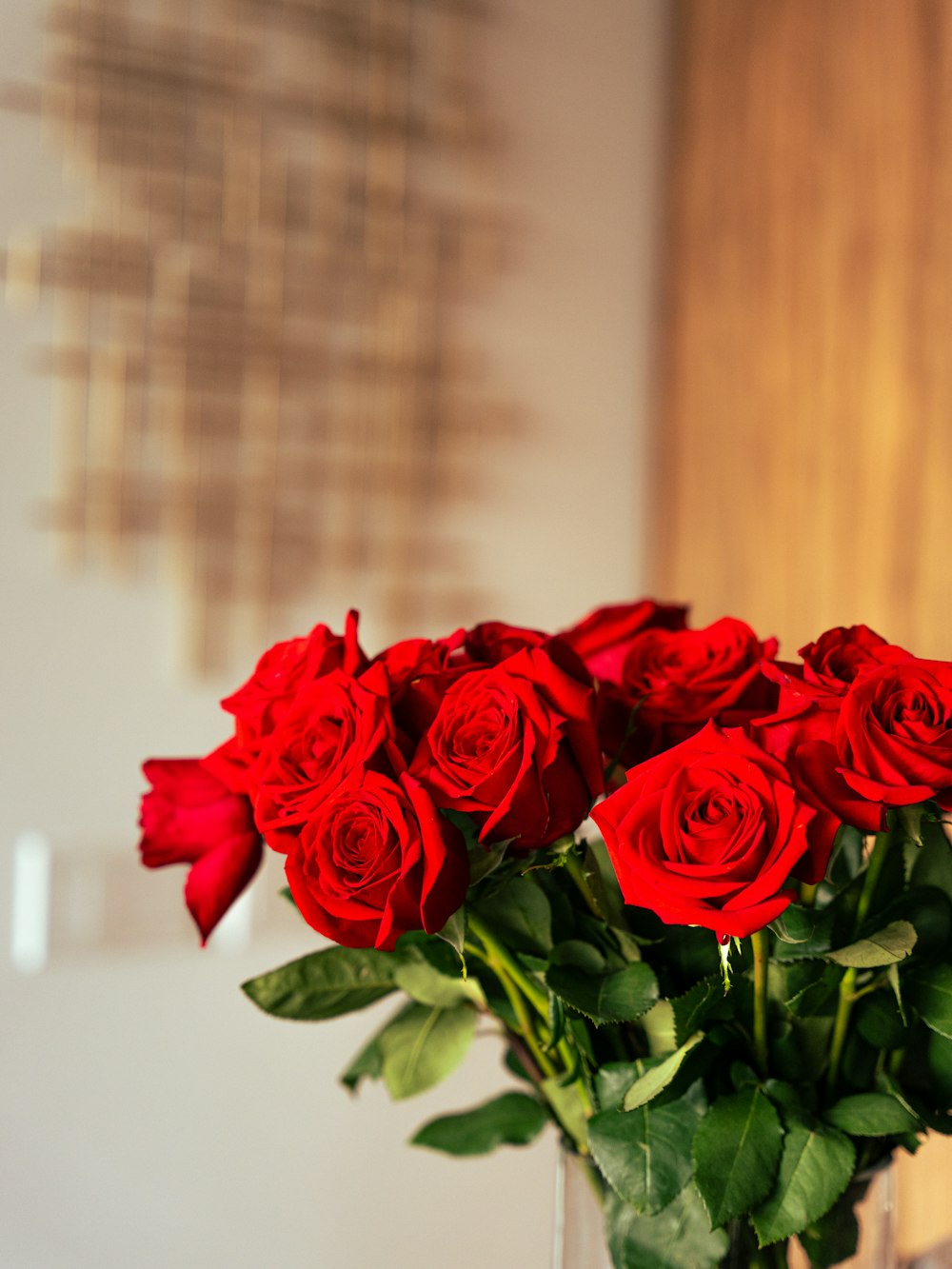 red roses in clear glass vase