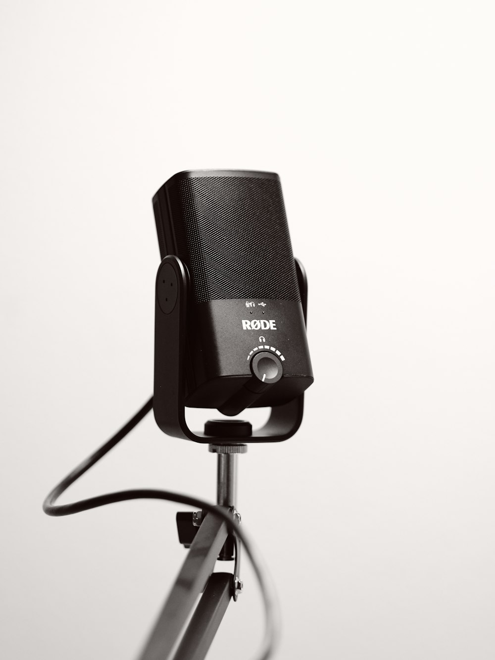 black and gray microphone on black microphone stand