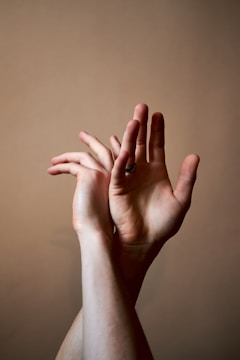 A detailed image focusing on a single hand sign with fingers intertwined uniquely.