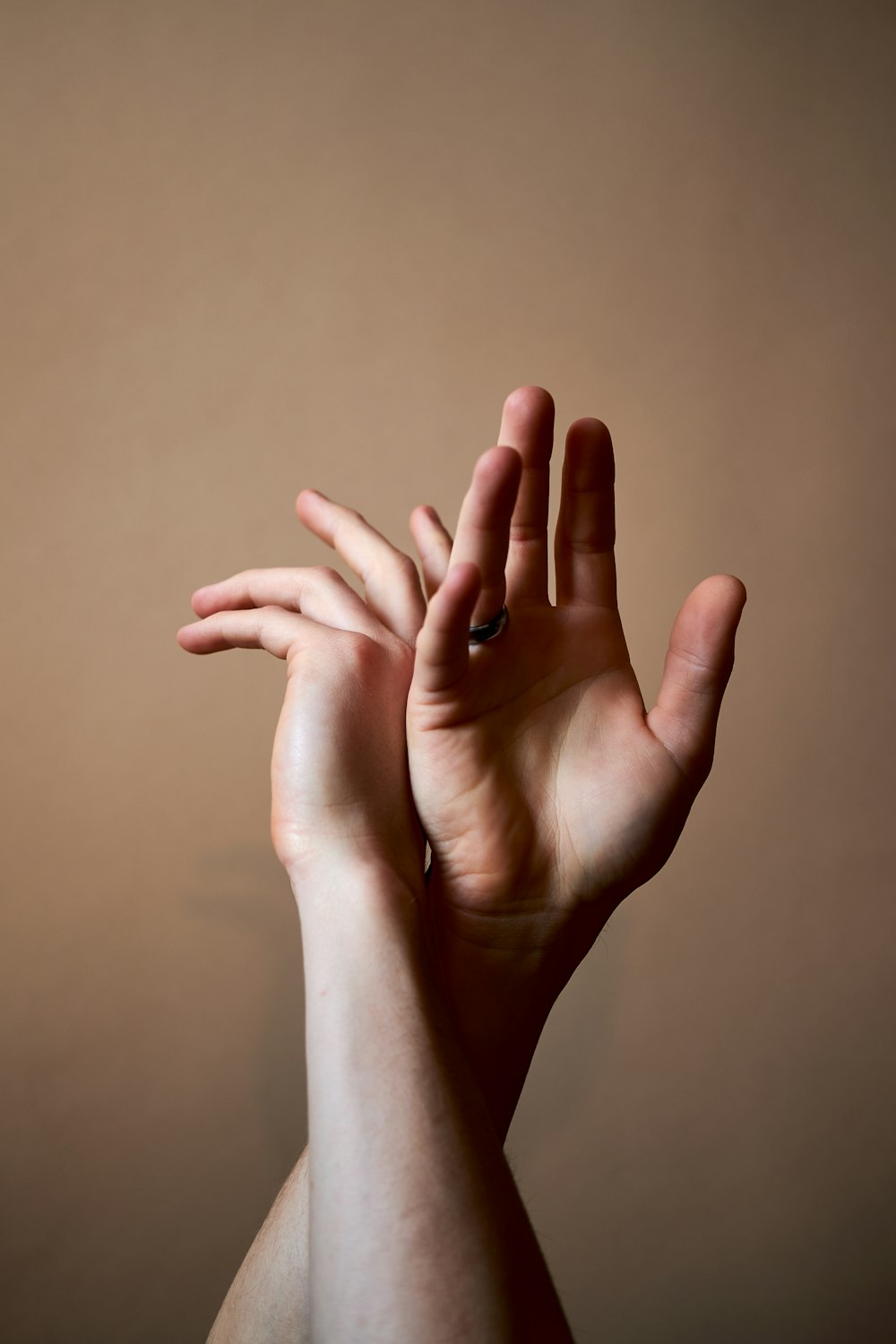 persons left hand on white wall