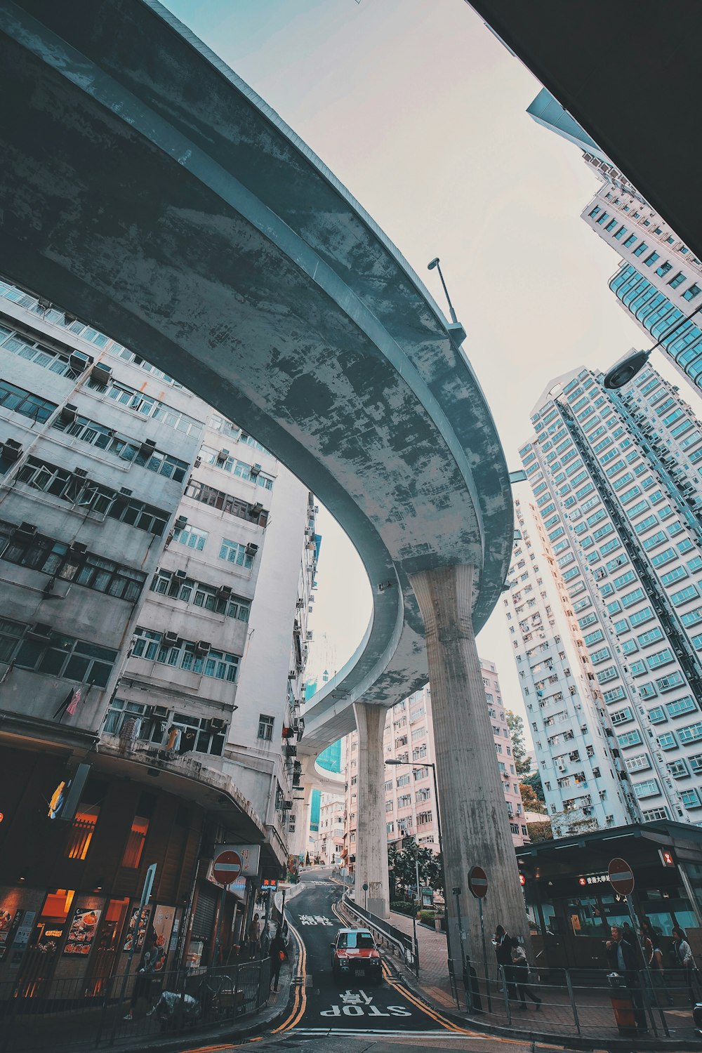 cars on road near high rise buildings during daytime