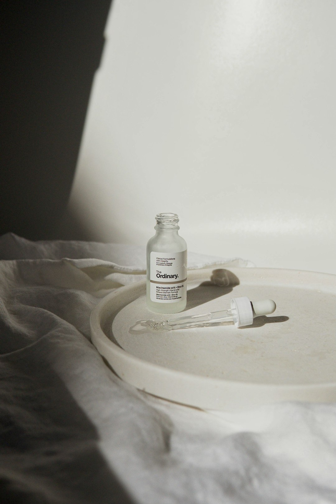 white plastic bottle on white round plate