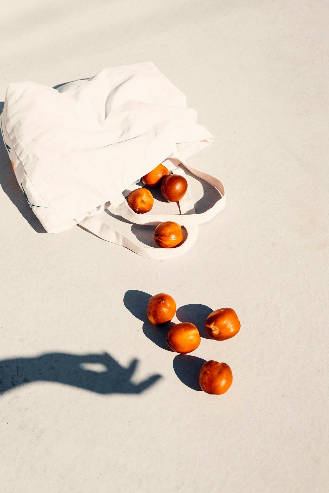 orange fruits on white textile