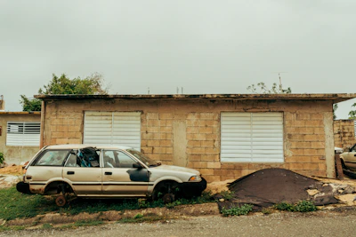 A non-running car with flat tires waiting for free pickup in Bronx.