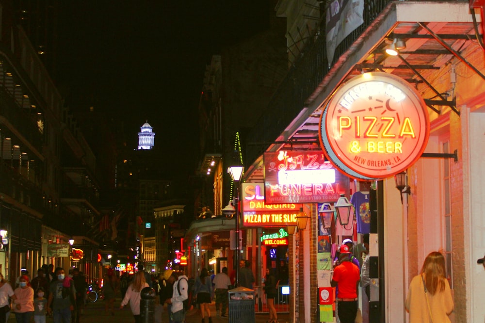 people walking on street during night time