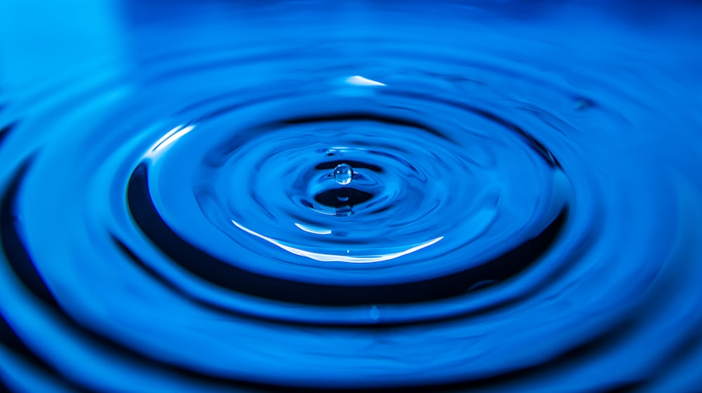 blue water drop in close up photography