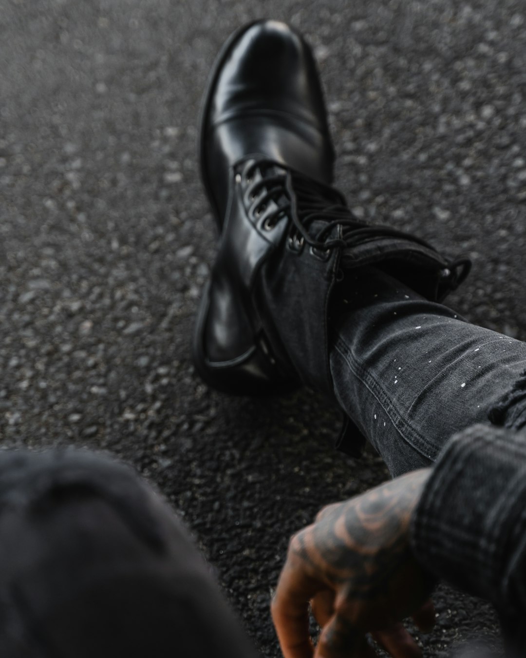 person in black leather boots