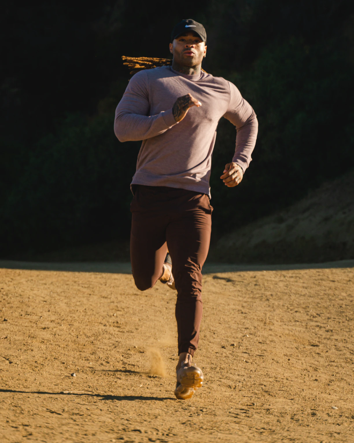 man in white long sleeve shirt and brown pants standing on brown field during daytime