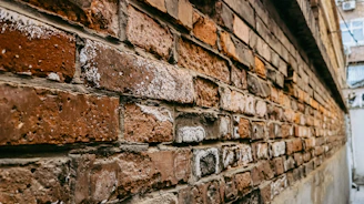 Before and after view of a brick home's exterior showing vibrant, renewed brick staining.