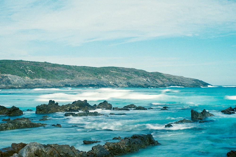 rocky shore under blue sky during daytime