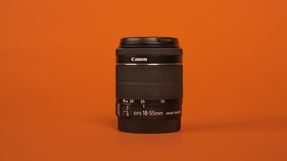 black camera lens on orange surface