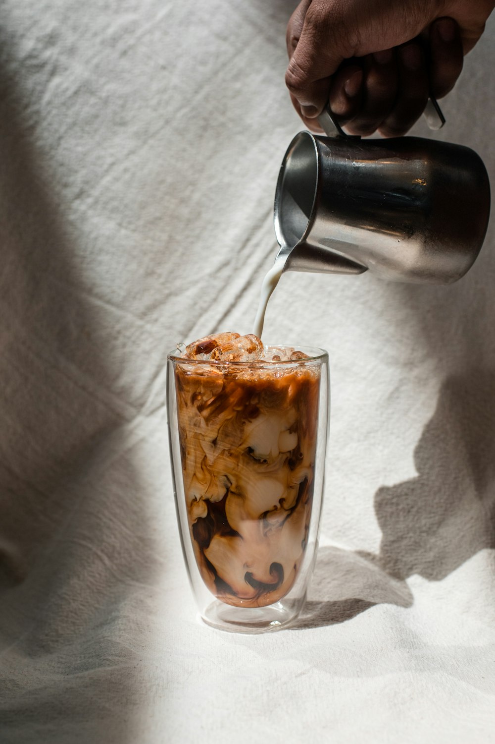 clear drinking glass with brown liquid