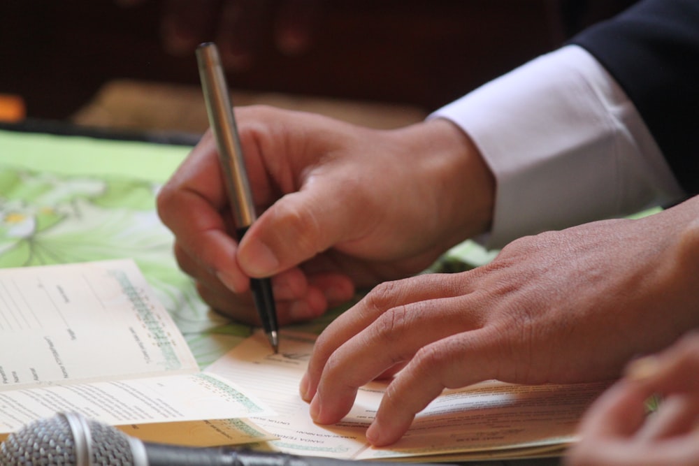 person writing on white paper