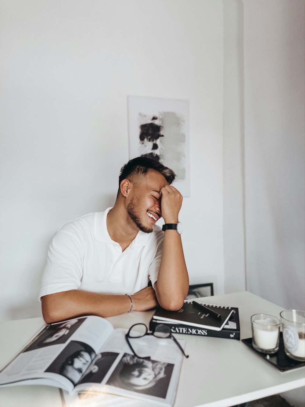 man in white crew neck t-shirt sitting on chair