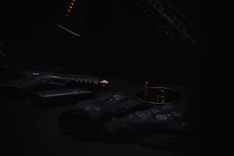 A sleek, tactical workspace with dark green accents and firearms neatly displayed under soft lighting.