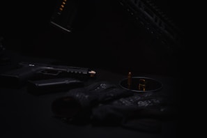 A collection of various suppressors arranged artistically on a black surface.