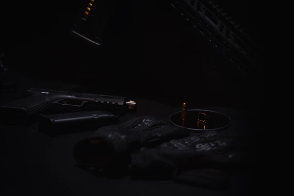 Close-up of a whistle and pepper spray on a dark background.