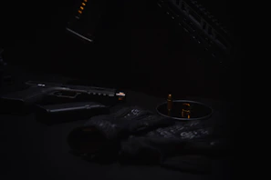 Tactical gear from HK arranged neatly on a gunmetal gray table with soft shadows.
