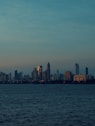 city skyline across body of water during daytime