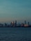 city skyline across body of water during daytime