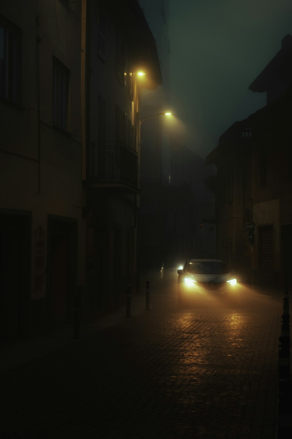 a car driving down a street at night