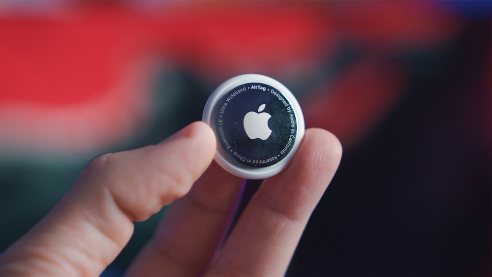 person holding black and white round plastic