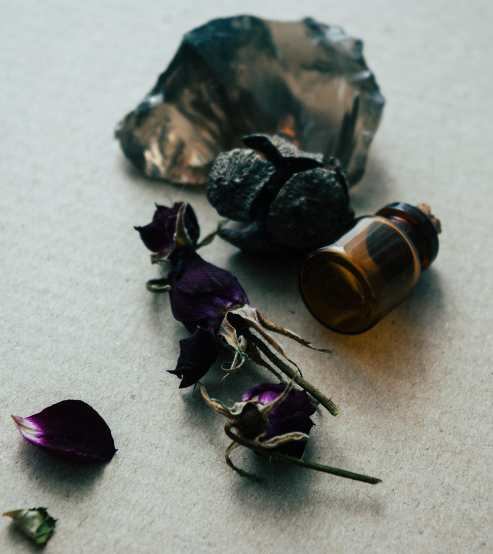 purple and brown stones on white textile