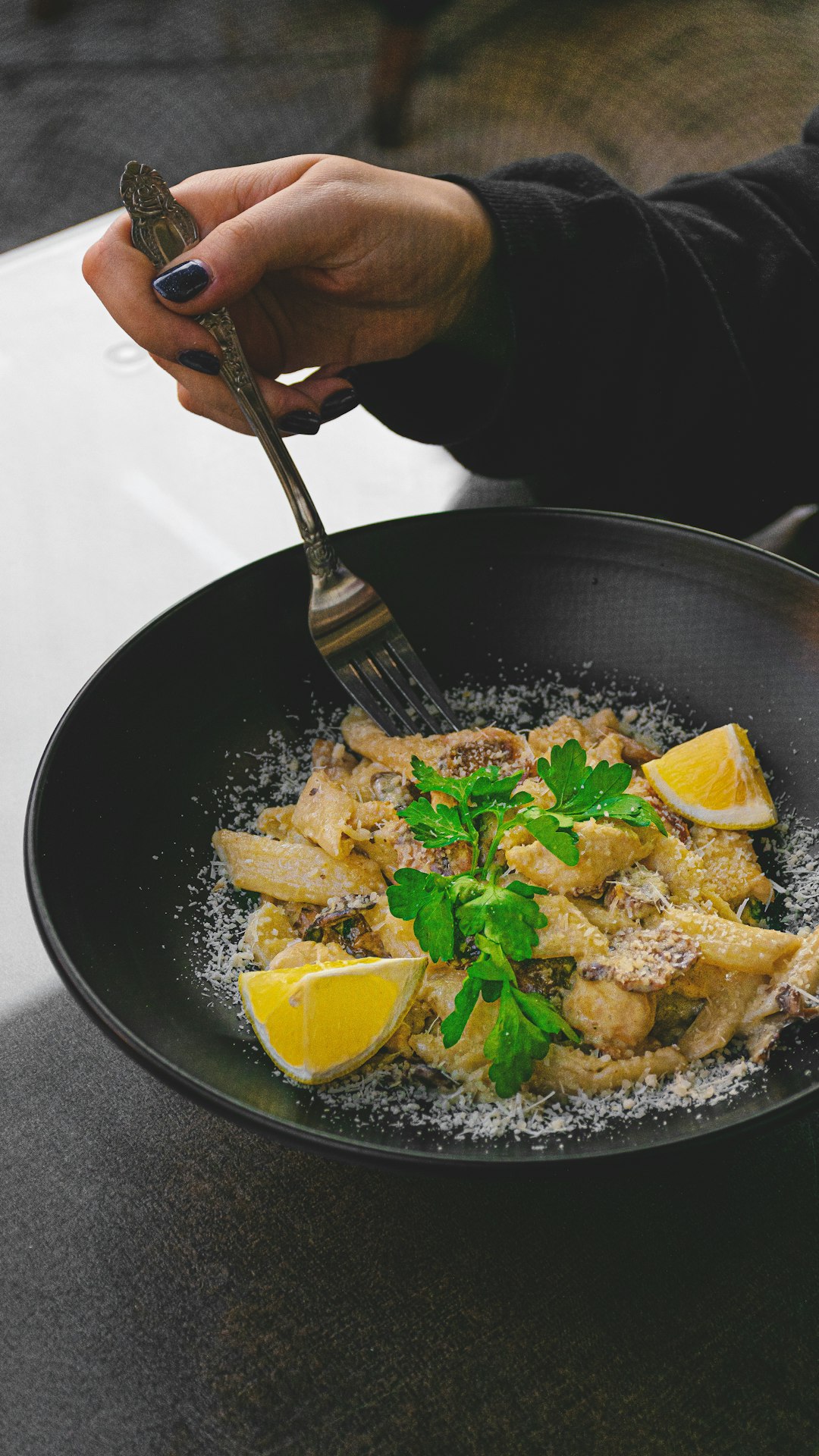 person holding fork and spoon