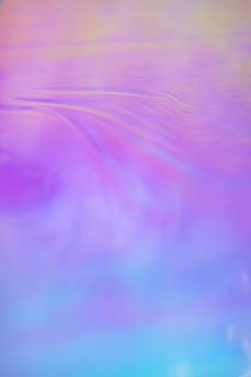 A whimsical splash of purple, lilac, and blue watercolor blending softly like a dreamy sky.