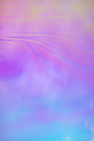 An outdoor mural painted with soft gradients of rose and lavender, evoking a calm and loving atmosphere.