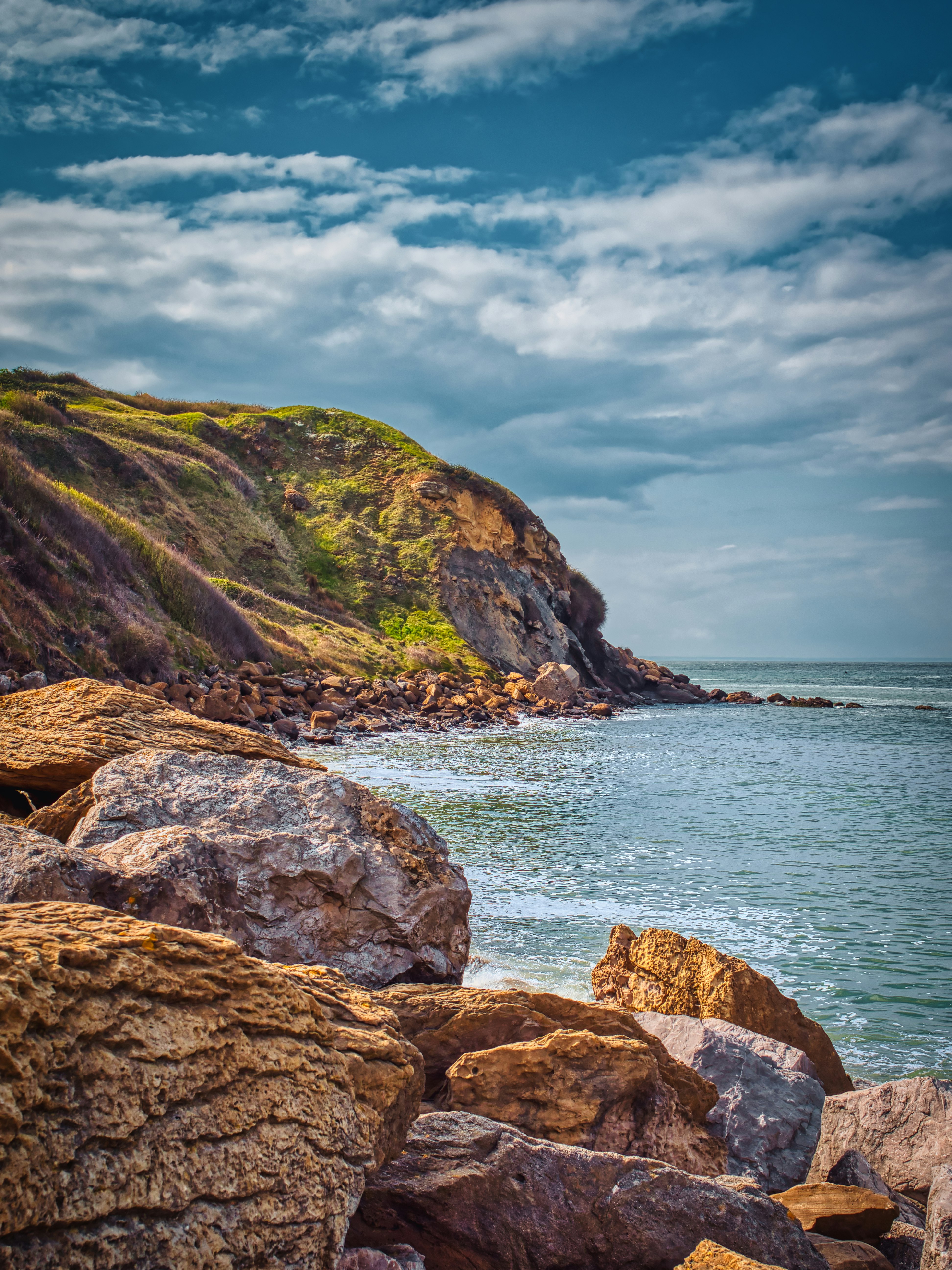 brown rock formation near body of water during daytime