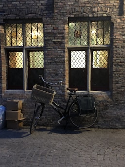 A cozy terrace scene with a bicycle leaning against a rustic wall, bathed in warm afternoon light.