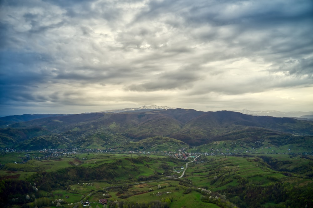 green mountains under cloudy sky during daytime