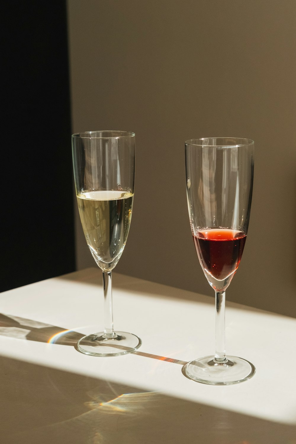 2 clear wine glasses on white table