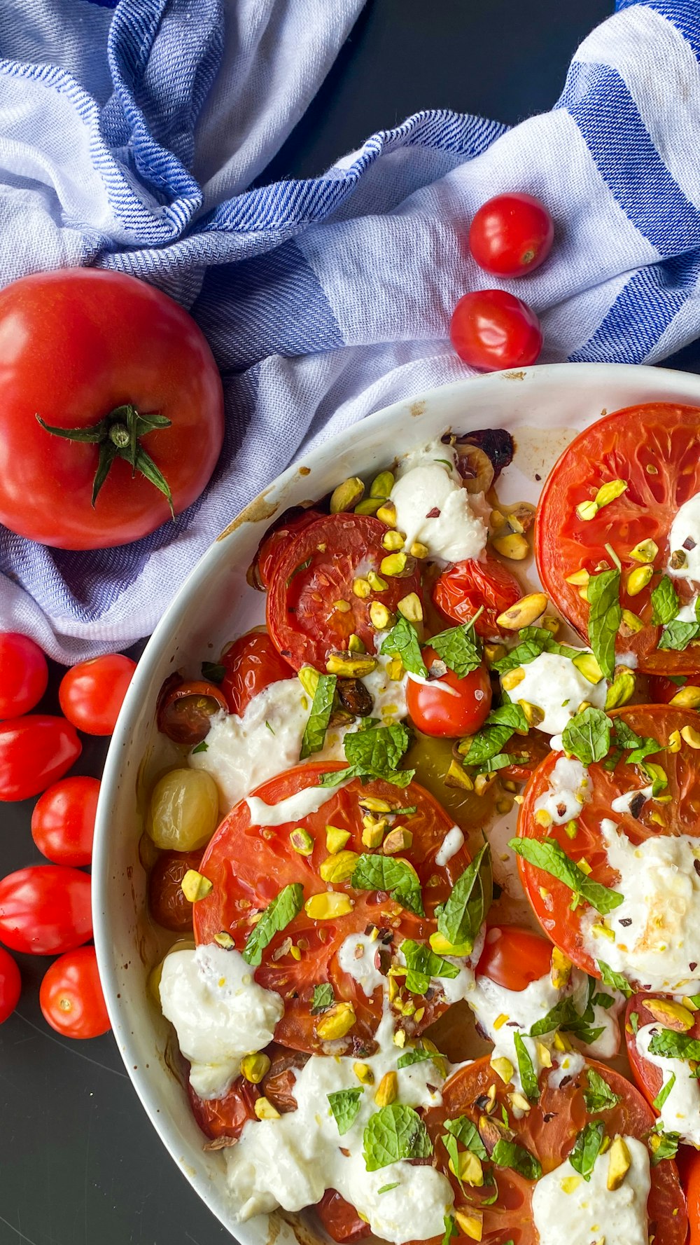 tomato and green vegetable salad on white ceramic bowl