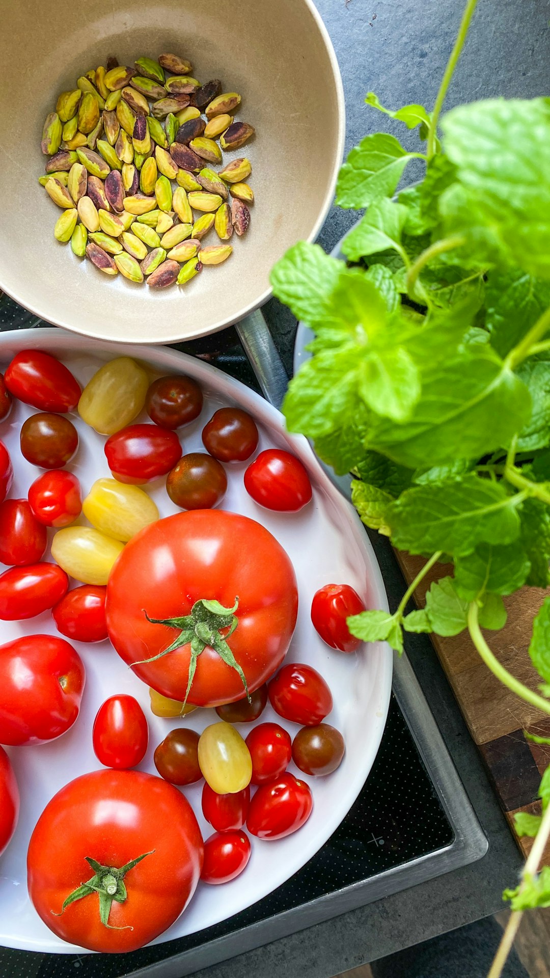 red tomato and green vegetable on white ceramic plate