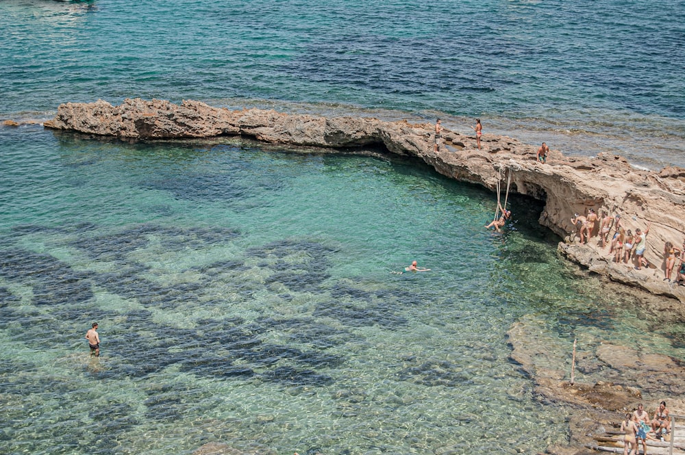 person in blue water during daytime