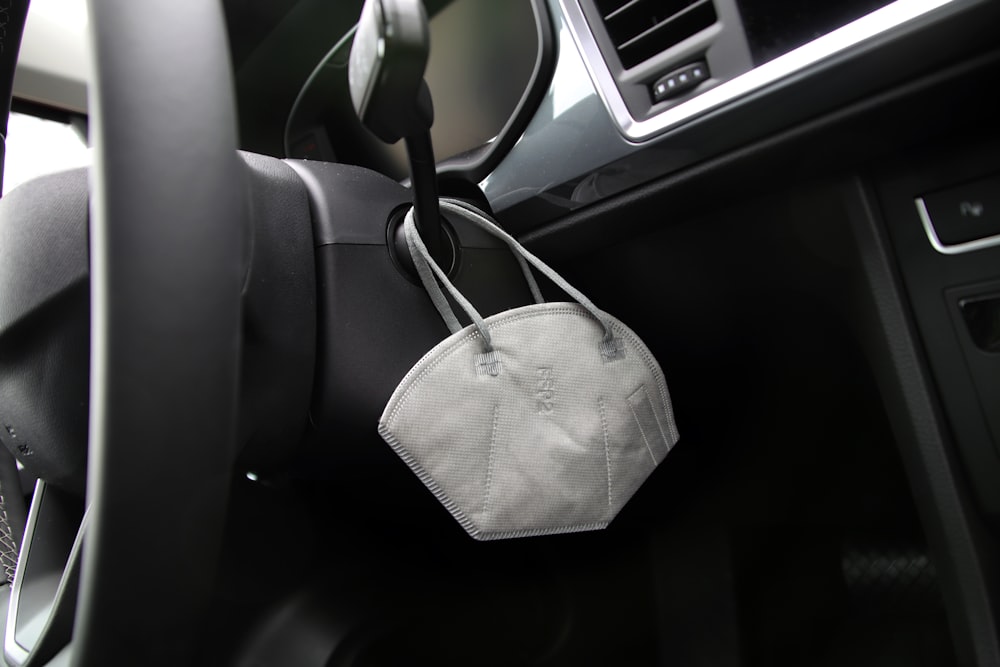 grey and white plaid pouch on car seat