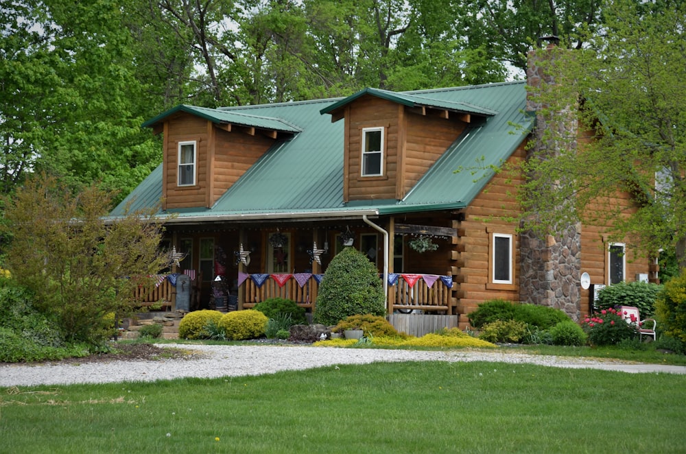 brown and white wooden house near green grass field during daytime