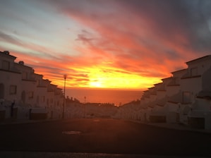 A vibrant sunset over Trancoso’s iconic colorful houses by the beach.