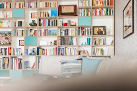 white wooden book shelf with books