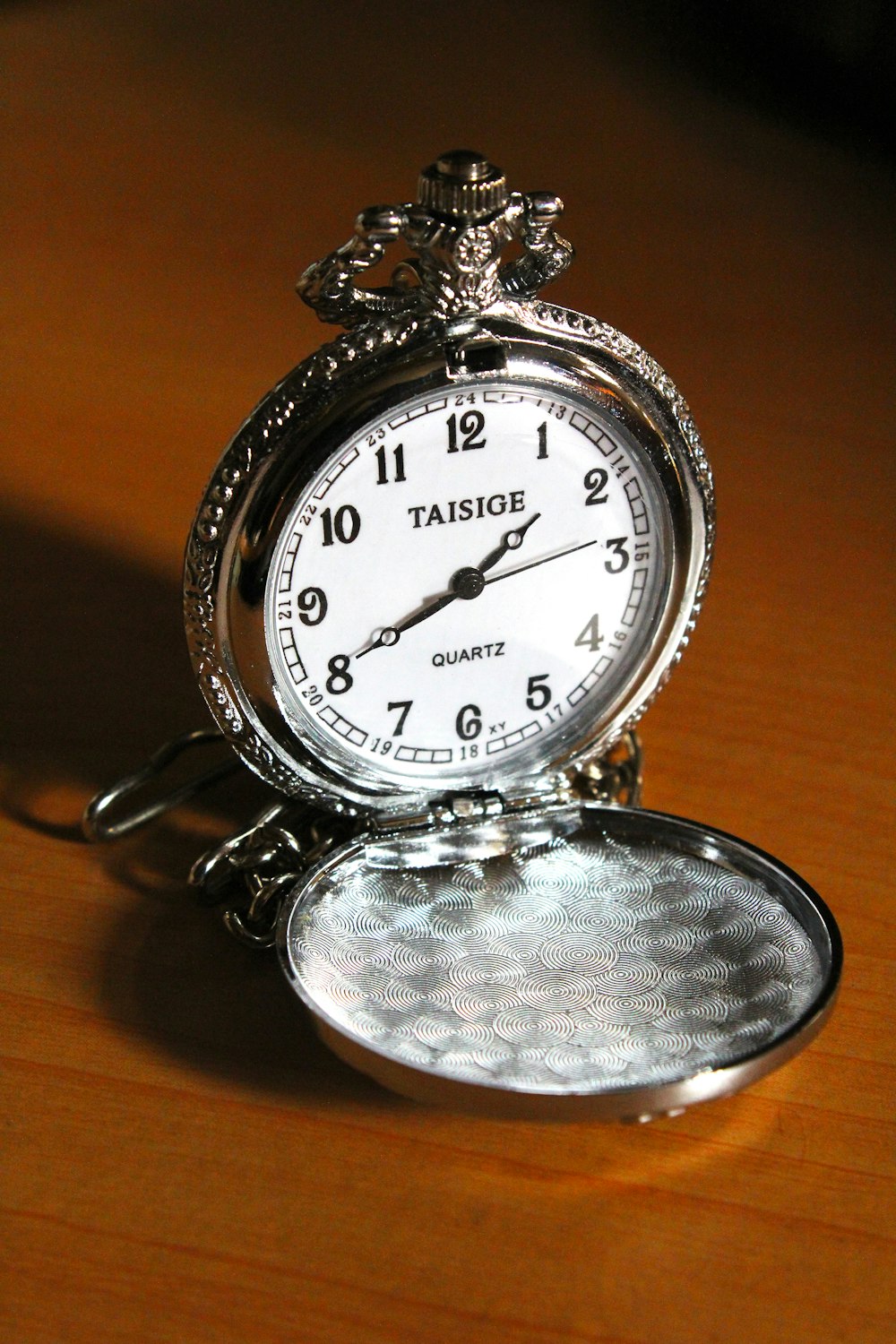silver and white round analog pocket watch