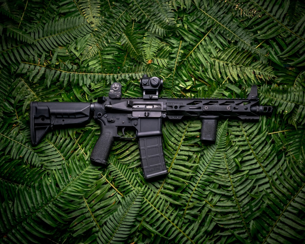 Foto Rifle sniper preto ao lado do alto-falante portátil JBL camuflado  verde, preto e branco – Imagem de Oberwartha grátis no Unsplash