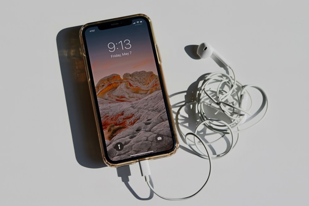black iphone 5 on white earphones