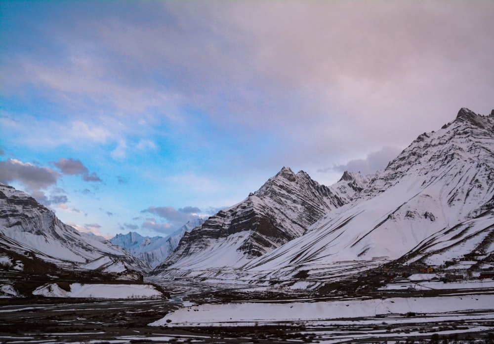 snow covered mountain under cloudy sky during daytime