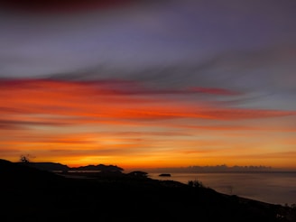A vibrant sunset over the Menorca coastline.