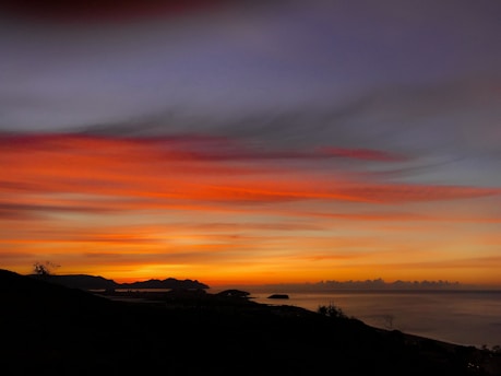 A vibrant sunset over the Menorca coastline.